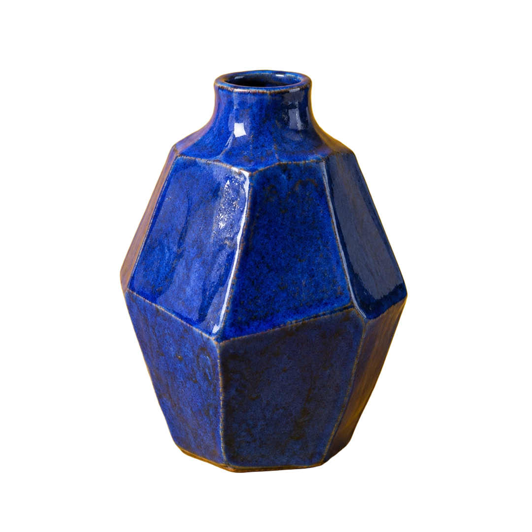 Cutout from a photo of an angular cobalt ceramic vase against marigold yellow
