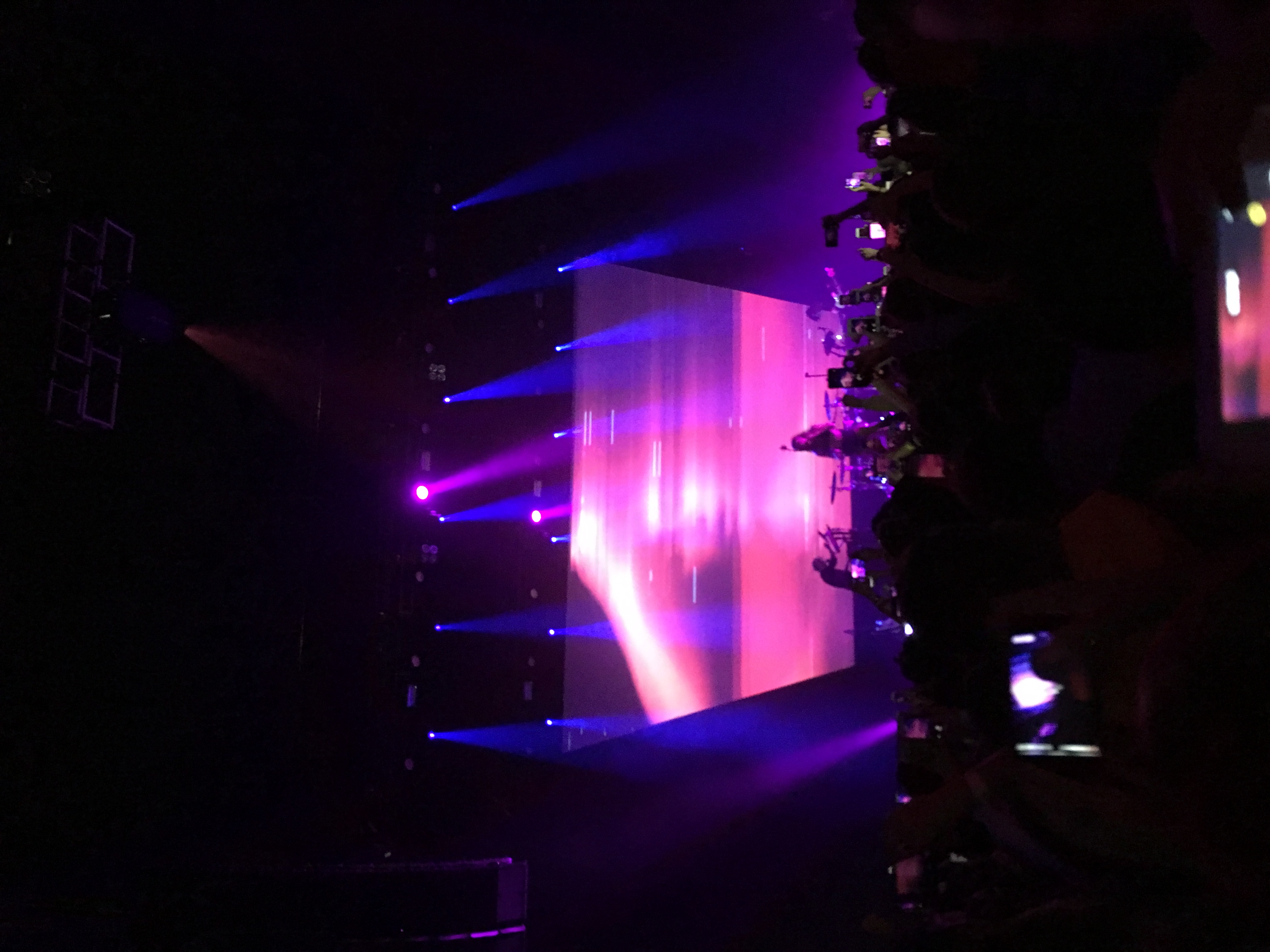 A concert stage washed in purple light.