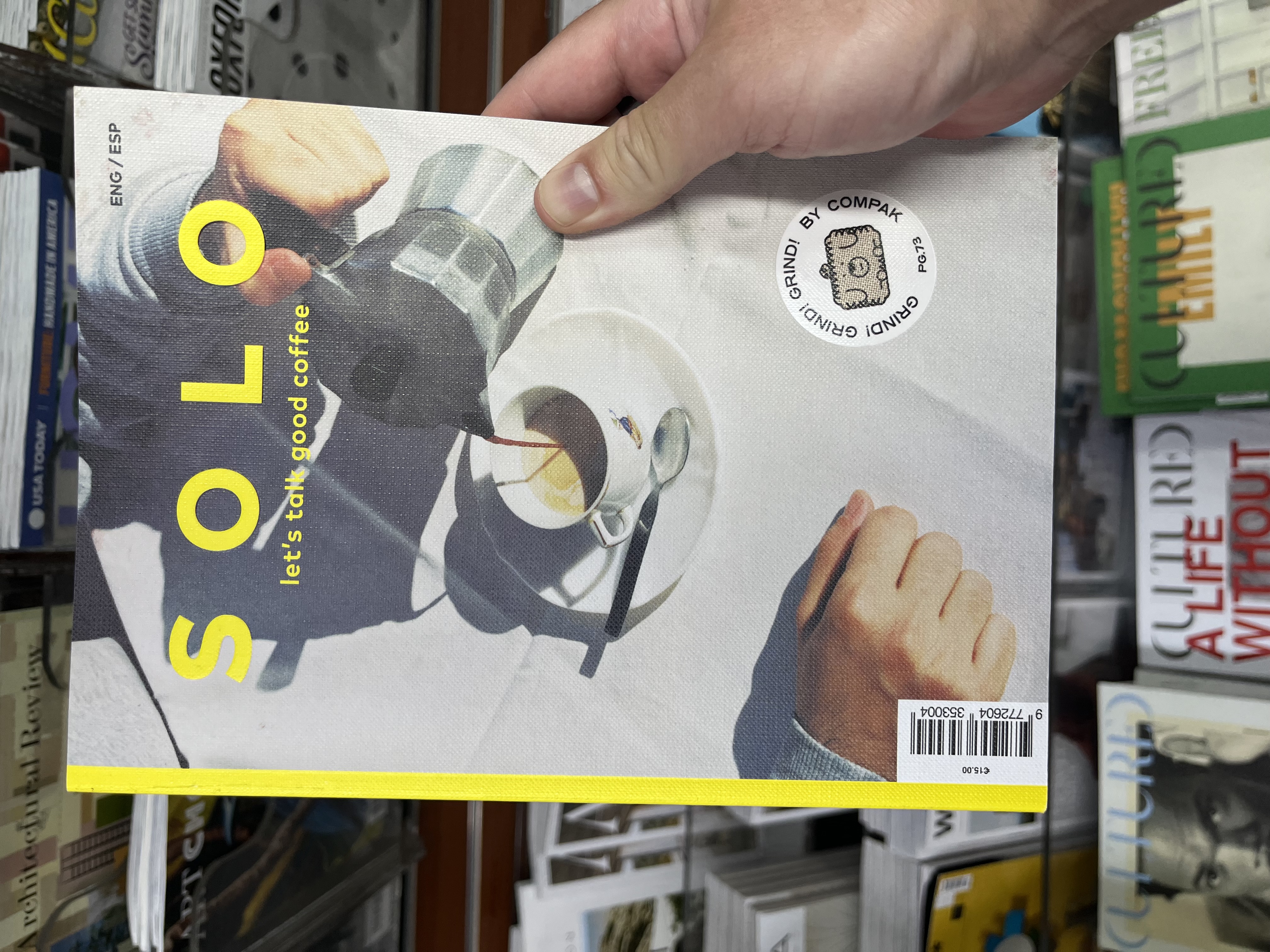 A coffee magazine held at a newsstand.