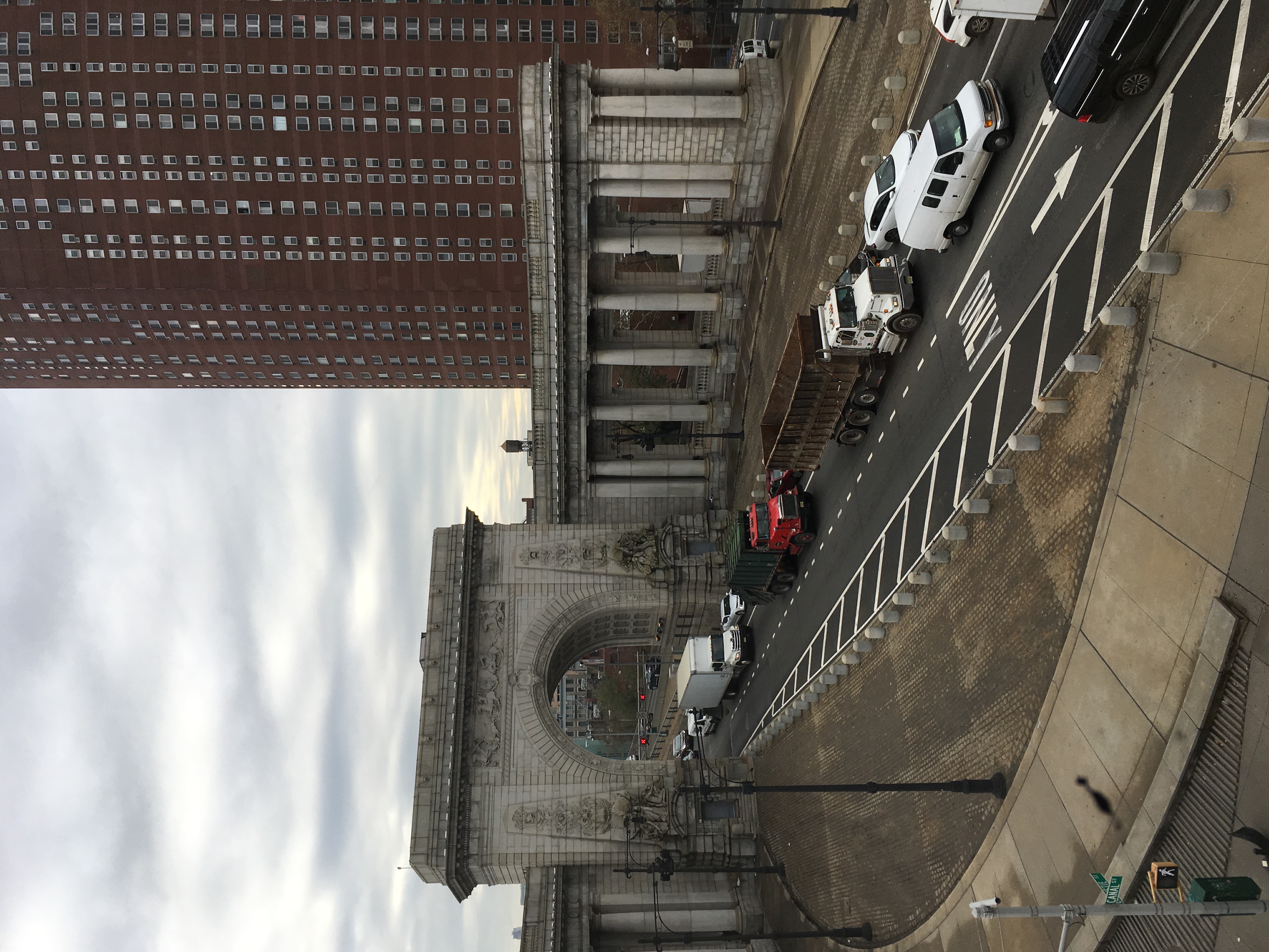 A bridge arch and colonnade over a truck route.